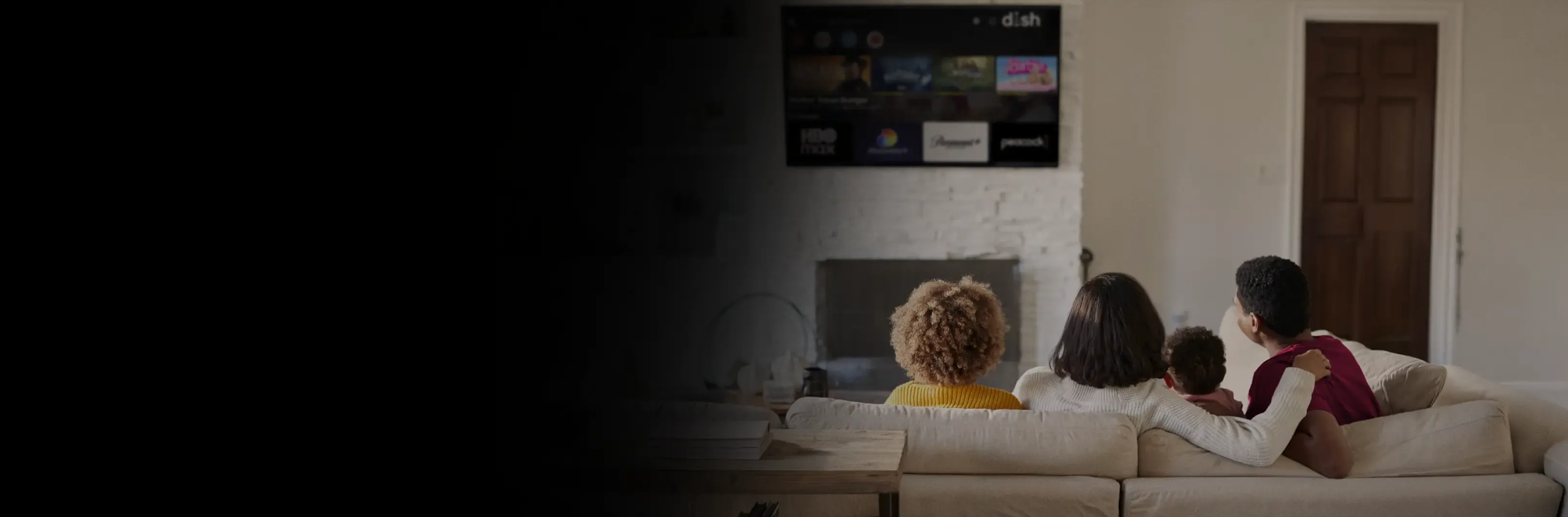 A family watches DISH streaming options on a TV above a fireplace.